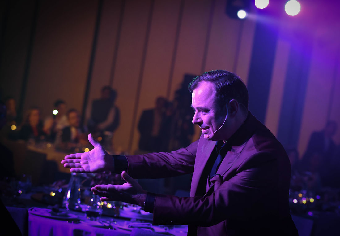 Fred Sharp performing on stage under blue and purple lighting